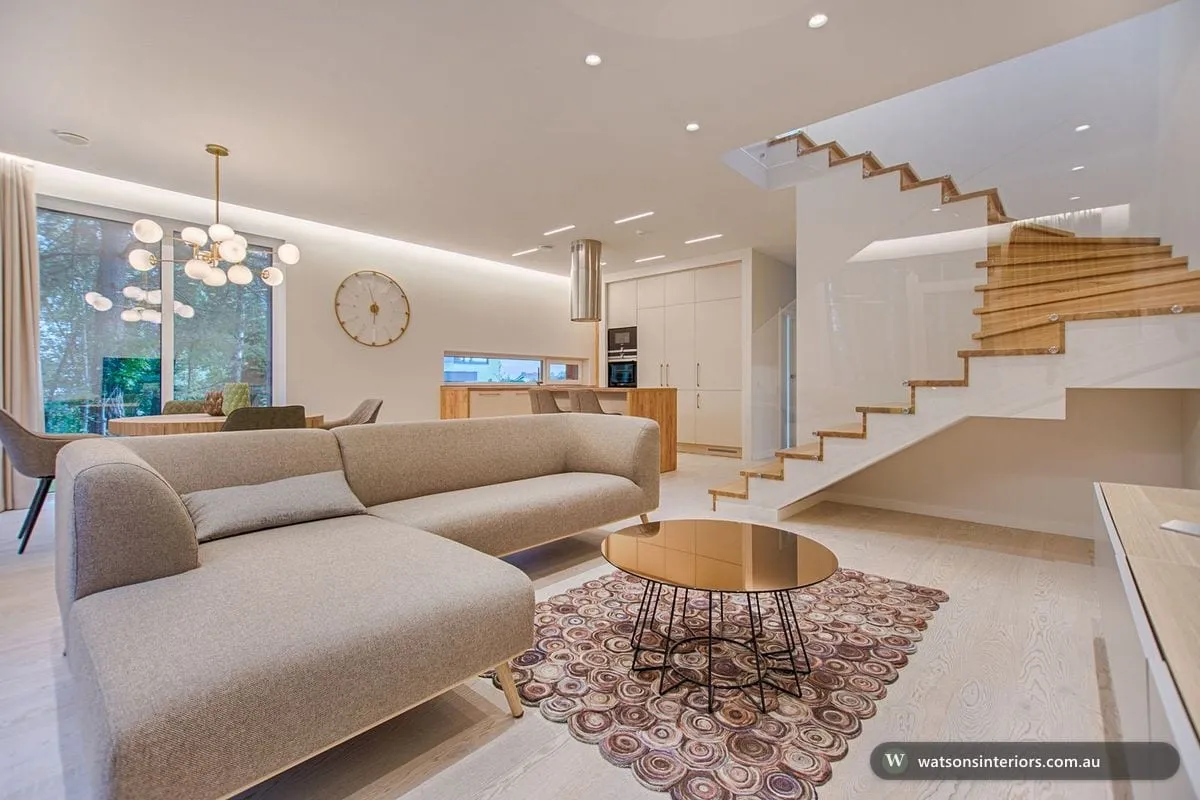 A bright, compact Australian living room styled with light timber, a neutral sofa and indoor plants